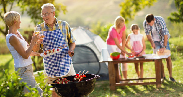 grandparents drinking wine and making barbeque for family