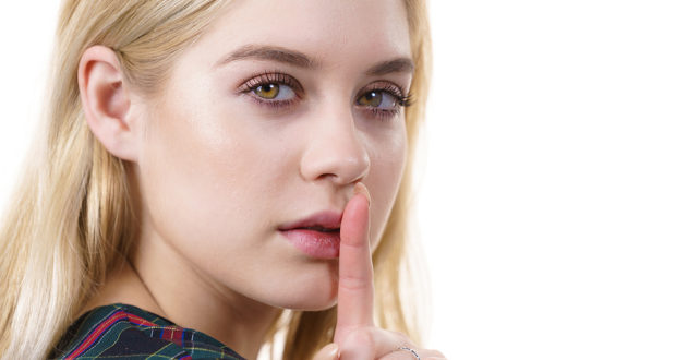 Close Up Of Young Blonde Woman Showing Silence Gesture With Fing